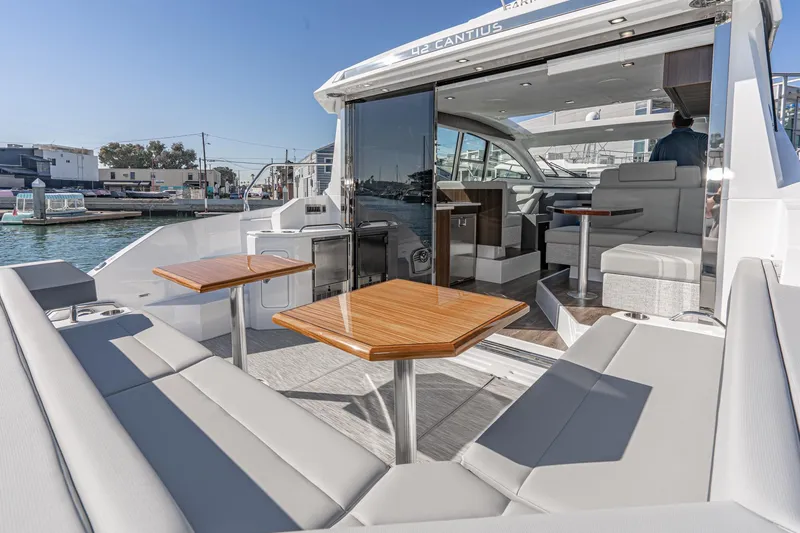 Slide: The Image of 2023 Cruisers Yachts 42 Cantius luxury yacht with spacious outdoor seating and modern interior. - 18