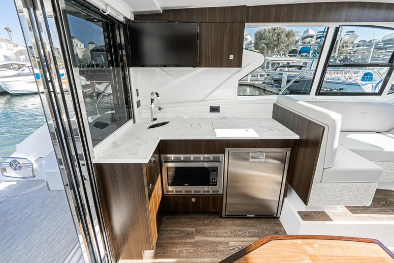 Slide: The Image of 2023 Cruisers Yachts 42 Cantius interior kitchen with modern appliances and waterfront view. - 25