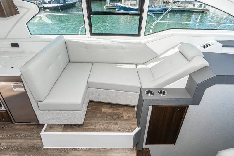 Slide: The Image of 2023 Cruisers Yachts 42 Cantius interior seating area with waterfront view. - 30