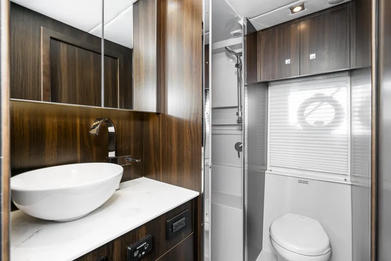 Slide: The Image of Modern bathroom interior of 2023 Cruisers Yachts 42 Cantius with sleek wood finishes. - 42