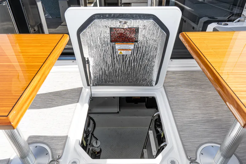 Slide: The Image of Open hatch on 2023 Cruisers Yachts 42 Cantius, revealing engine compartment. - 44