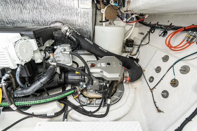 Slide: The Image of Engine compartment of a 2023 Cruisers Yachts 42 Cantius with visible components and wiring. - 45