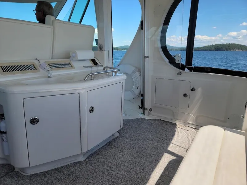 Slide: The Image of Interior of 2003 Sea Ray 390 Motor Yacht with white cabinetry and lake view. - 11
