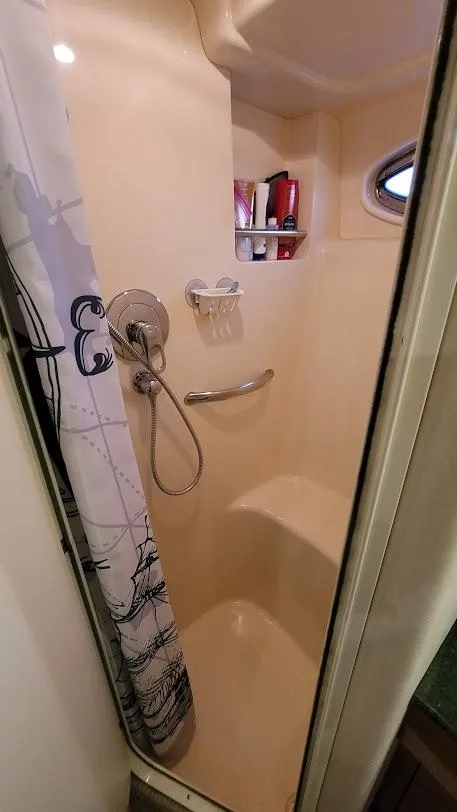 Slide: The Image of 2003 Sea Ray 390 Motor Yacht bathroom with toilet and shower. - 27