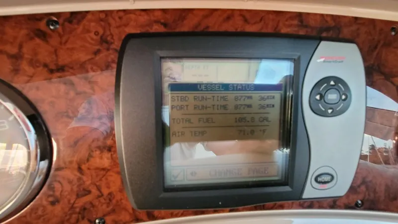 Slide: The Image of Hand holding remote control in 2003 Sea Ray 390 Motor Yacht cockpit with navigation screens. - 29
