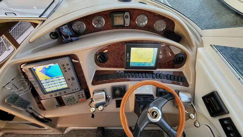 Slide: The Image of 2003 Sea Ray 390 Motor Yacht helm with navigation screens and controls. - 3