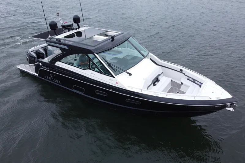 The Image of 2022 Formula 380 Super Sport Crossover OB boat on water, rear view with triple outboard engines. - 0