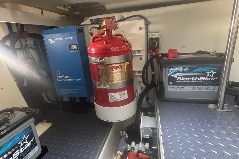 Slide: The Image of 2022 Formula 380 Super Sport Crossover OB engine room with battery charger and fire extinguisher. - 106