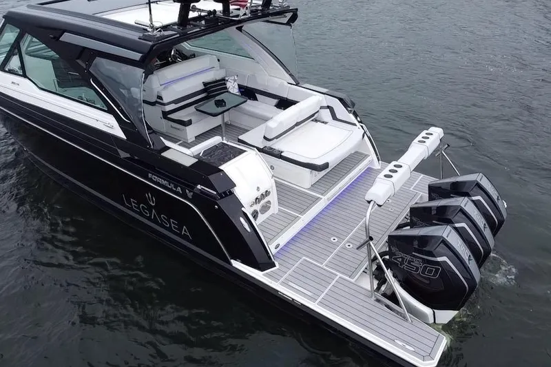 Slide: The Image of 2022 Formula 380 Super Sport Crossover OB on water, featuring triple outboard engines. - 11