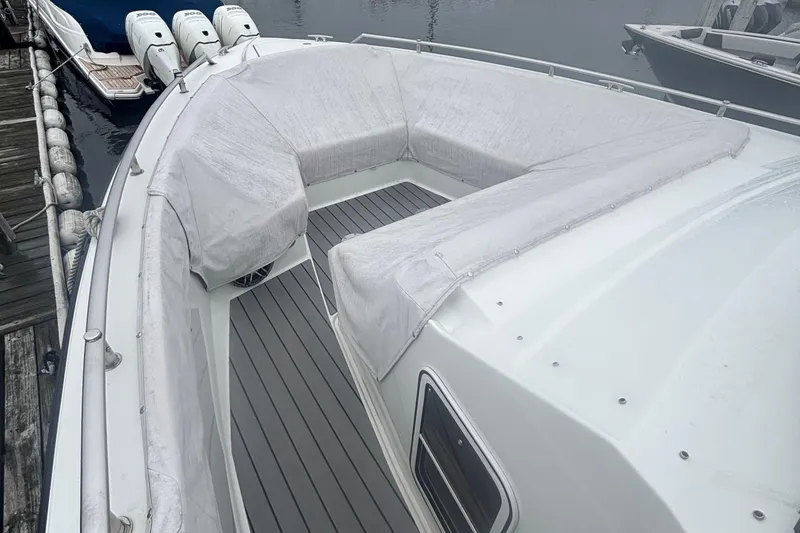 Slide: The Image of 2022 Formula 380 Super Sport Crossover OB with covered seating and triple outboard engines. - 110