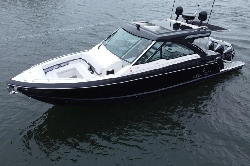 Slide: The Image of 2022 Formula 380 Super Sport Crossover OB boat on water, sleek black design. - 19