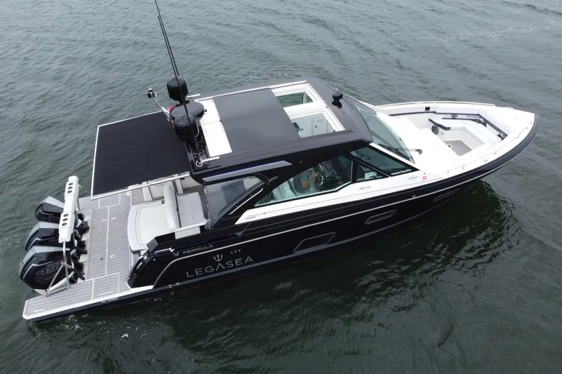 Slide: The Image of 2022 Formula 380 Super Sport Crossover OB boat on water, featuring sleek design and powerful engines. - 20