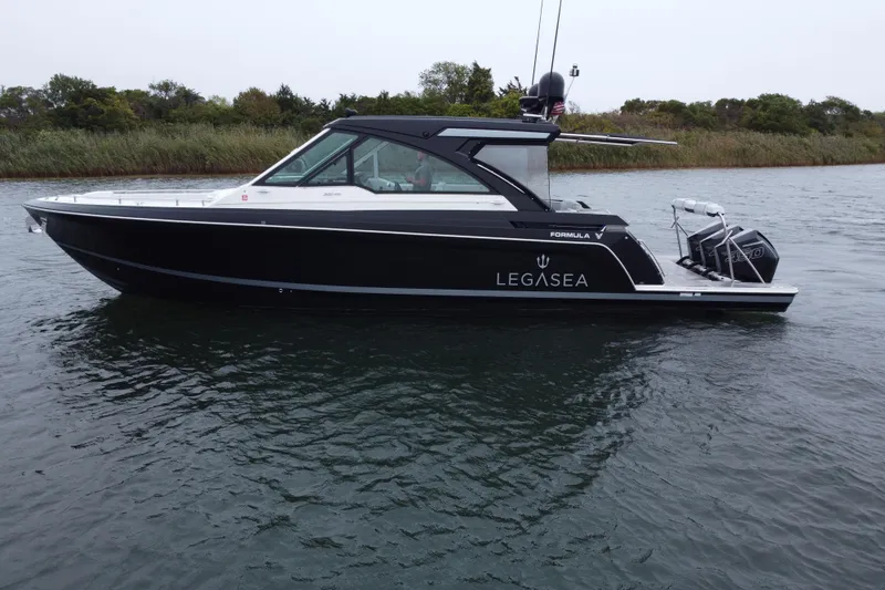 Slide: The Image of 2022 Formula 380 Super Sport Crossover OB boat on water, side view. - 24