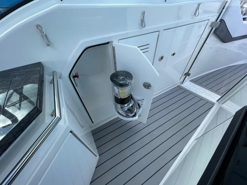 Slide: The Image of 2022 Formula 380 Super Sport Crossover boat with open storage compartment. - 32