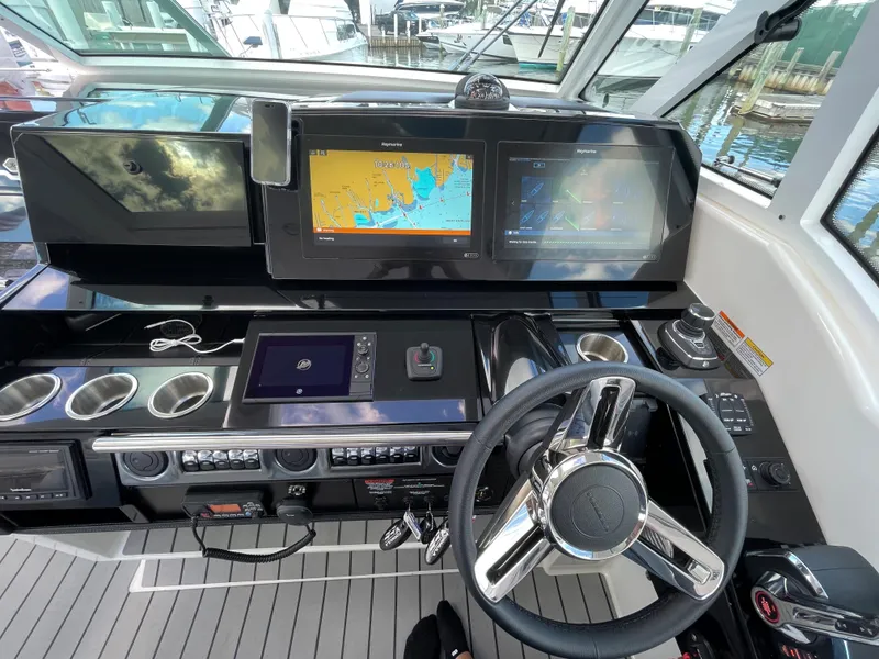Slide: The Image of 2022 Formula 380 Super Sport Crossover helm with navigation screens and controls. - 33