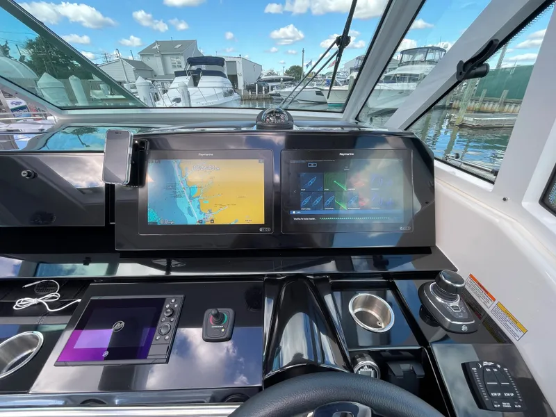 Slide: The Image of 2022 Formula 380 Super Sport Crossover helm with dual navigation screens and joystick control. - 34
