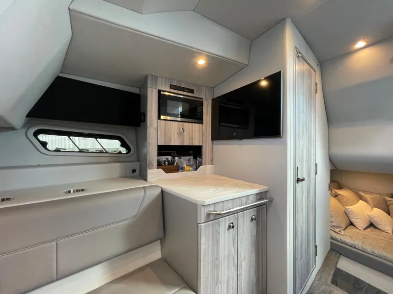 Slide: The Image of 2022 Formula 380 Super Sport Crossover OB interior with modern kitchenette and cozy seating area. - 39