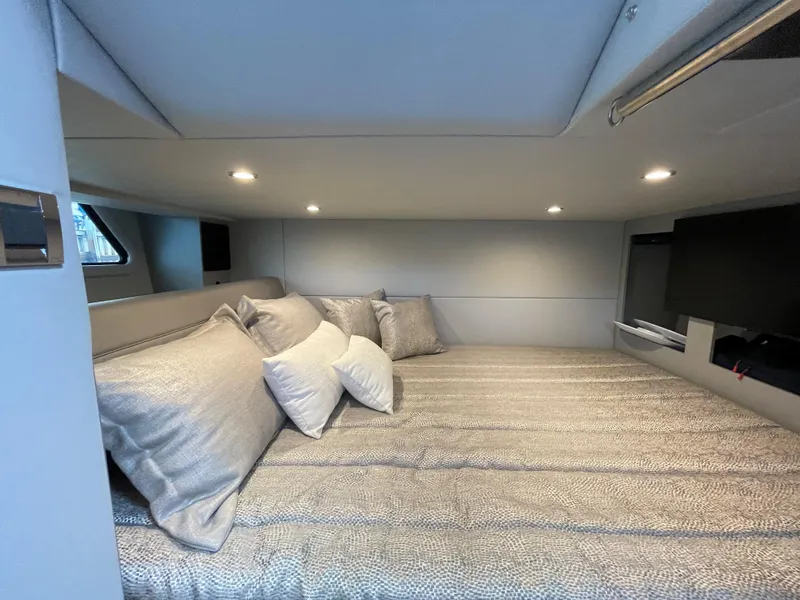 Slide: The Image of 2022 Formula 380 Super Sport Crossover OB cabin with cozy bedding and ambient lighting. - 41