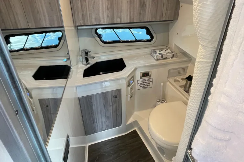 Slide: The Image of 2022 Formula 380 Super Sport Crossover OB bathroom with modern fixtures and wood accents. - 43