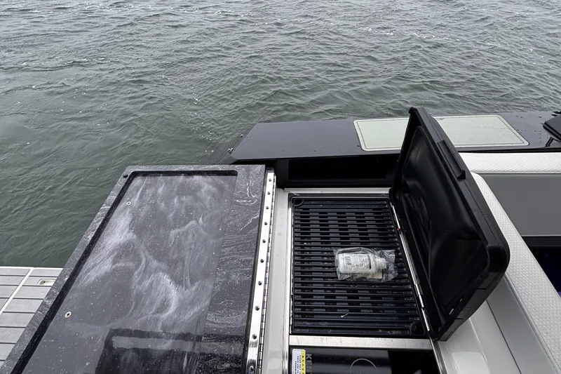 Slide: The Image of Outdoor grill on 2022 Formula 380 Super Sport Crossover OB boat, near water. - 50