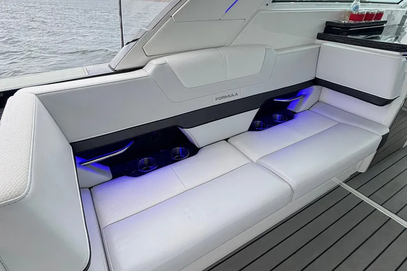 Slide: The Image of 2022 Formula 380 Super Sport Crossover OB interior with sleek white seating and blue LED lighting. - 59