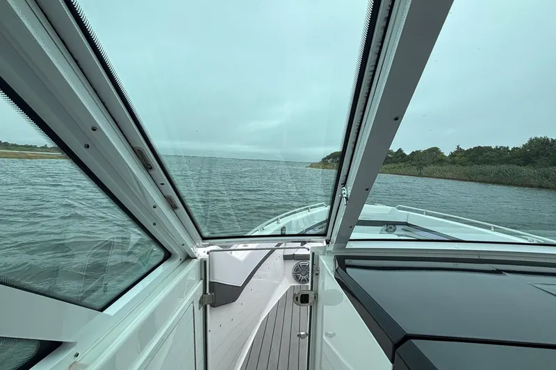 Slide: The Image of View from 2022 Formula 380 Super Sport Crossover OB boat, overlooking serene waters and shoreline. - 61