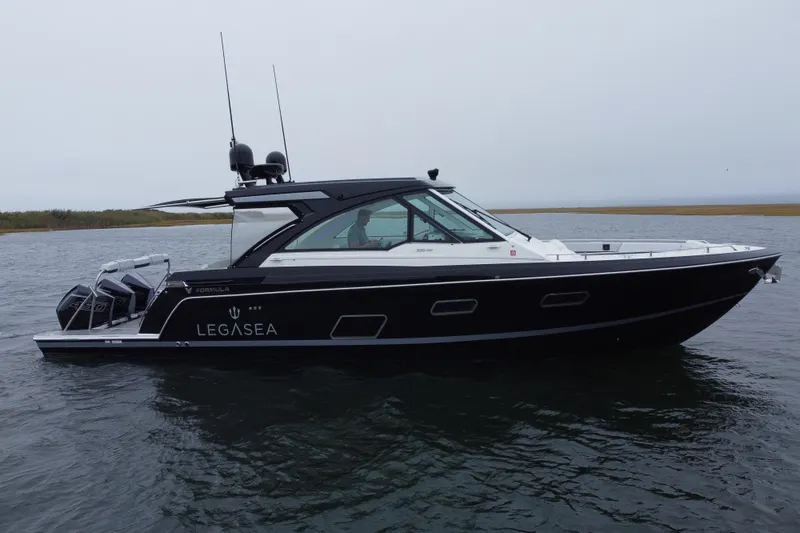 Slide: The Image of 2022 Formula 380 Super Sport Crossover OB boat on water, side view. - 7