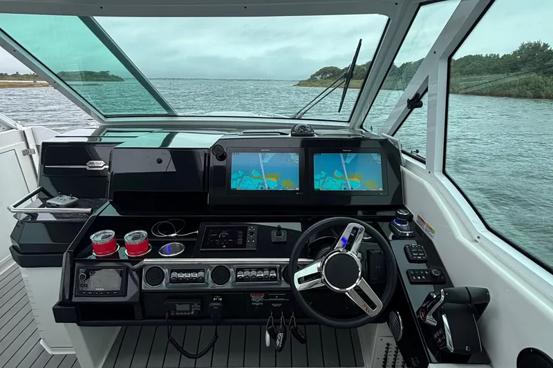 Slide: The Image of 2022 Formula 380 Super Sport Crossover OB helm with dual navigation screens on open water. - 72