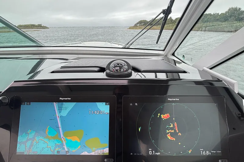 Slide: The Image of Cockpit view of 2022 Formula 380 Super Sport Crossover OB with navigation screens. - 74