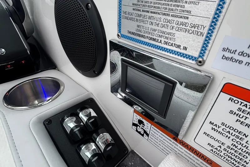 Slide: The Image of Control panel of 2022 Formula 380 Super Sport Crossover OB boat with safety labels. - 75
