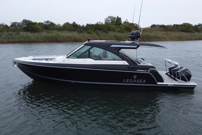 Slide: The Image of 2022 Formula 380 Super Sport Crossover OB boat on water, side view. - 8