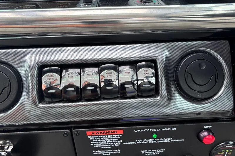 Slide: The Image of Control panel of a 2022 Formula 380 Super Sport Crossover OB boat with labeled switches. - 81
