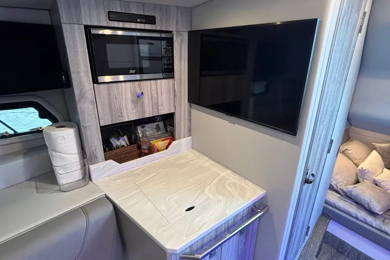 Slide: The Image of Interior of 2022 Formula 380 Super Sport Crossover OB with TV, microwave, and storage. - 87