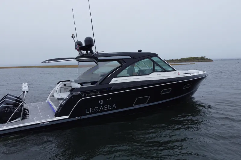 Slide: The Image of 2022 Formula 380 Super Sport Crossover OB boat on calm water. - 9