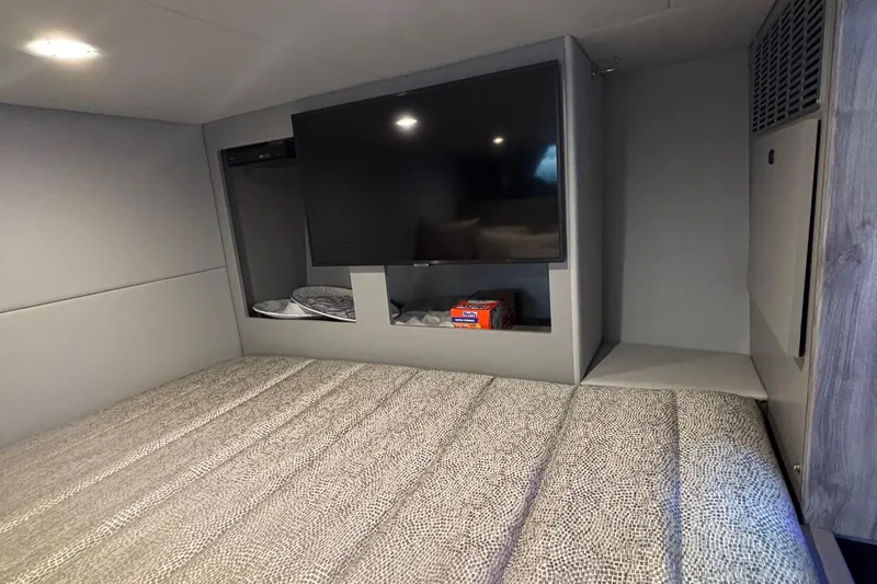 Slide: The Image of 2022 Formula 380 Super Sport Crossover OB cabin with TV and cozy bed. - 91