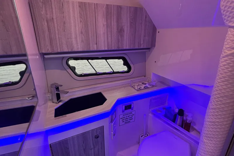 Slide: The Image of 2022 Formula 380 Super Sport Crossover OB interior bathroom with modern design and blue lighting. - 93