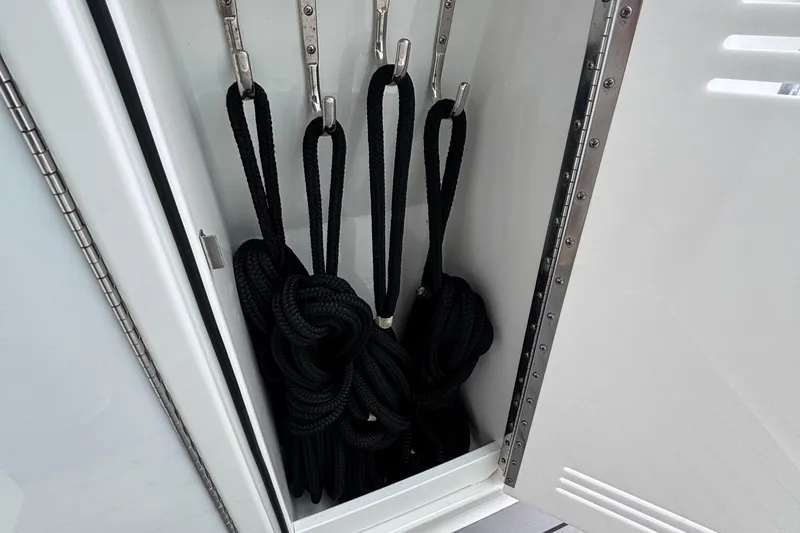 Slide: The Image of Storage compartment with black ropes on a 2022 Formula 380 Super Sport Crossover OB. - 97