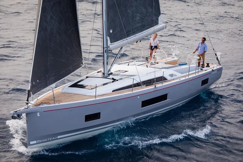 Slide: The Image of 2024 Beneteau Oceanis 46.1 sailing on open water with two people on deck. - 10