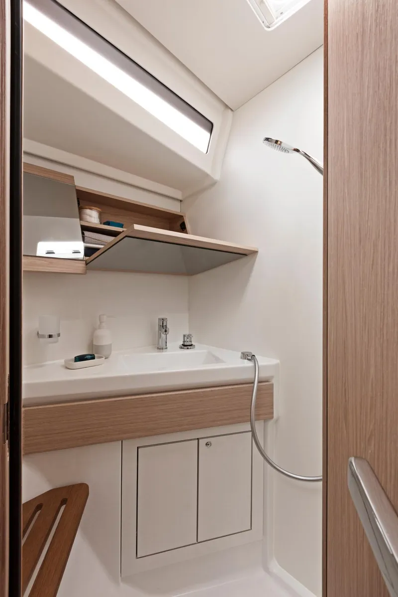 Slide: The Image of Modern bathroom in 2024 Beneteau Oceanis 46.1 yacht with sink and storage. - 25