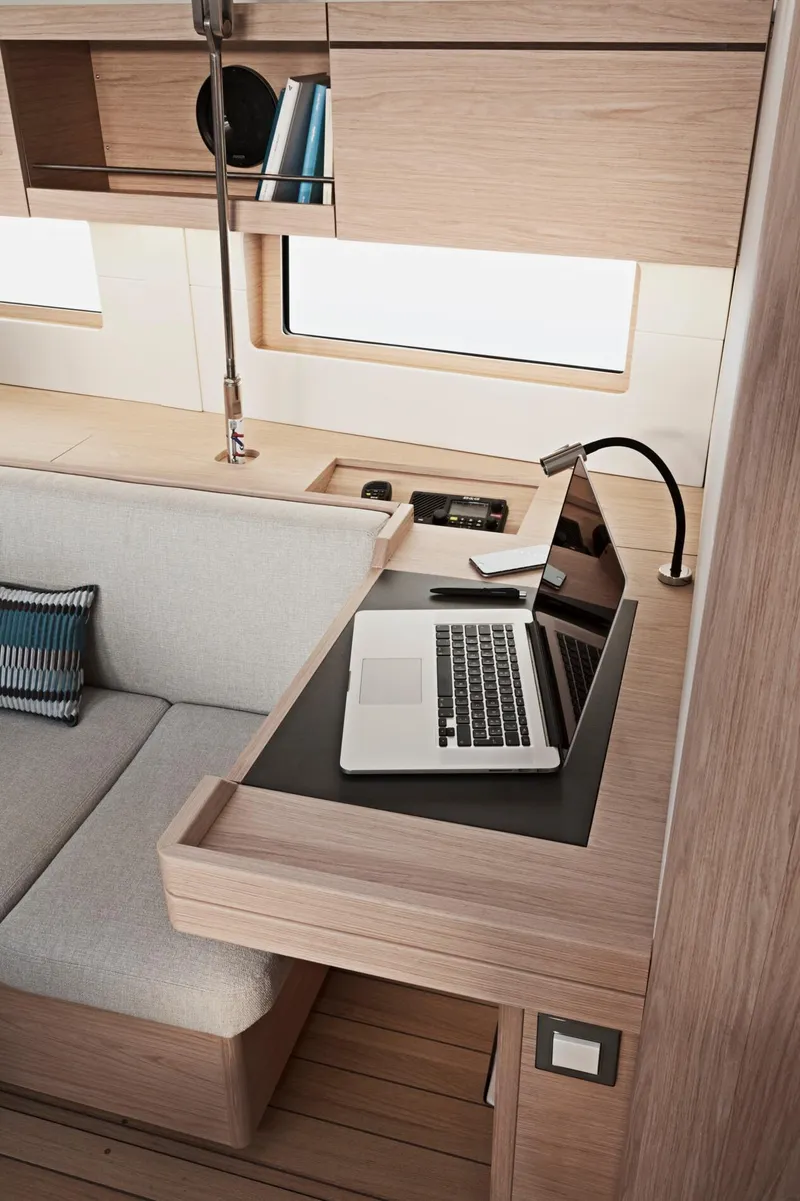Slide: The Image of 2024 Beneteau Oceanis 46.1 interior with a modern workspace and laptop. - 33