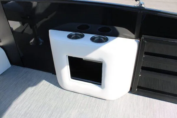 Slide: The Image of 2023 Lowe SS250 Super Sport boat interior with cup holders and storage compartment. - 2