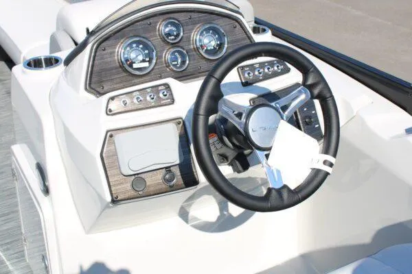 Slide: The Image of 2023 Lowe SS250 Super Sport boat dashboard with steering wheel and control gauges. - 3