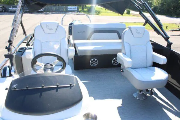 Slide: The Image of 2023 Lowe SS250 Super Sport boat interior with white seating and steering console. - 4
