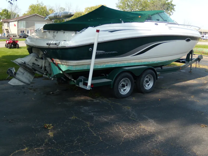 Slide: The Image of 2000 Chaparral 235 SSi boat on a trailer with green cover. - 1