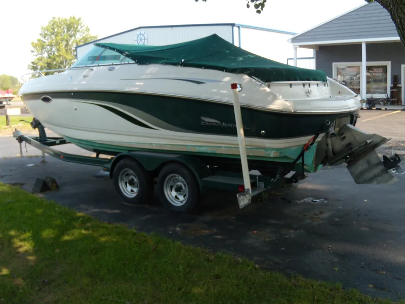 Slide: The Image of 2000 Chaparral 235 SSi boat on a trailer, covered with a green tarp. - 2