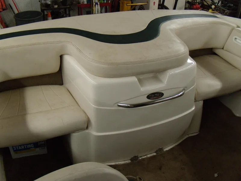Slide: The Image of 2000 Chaparral 235 SSi boat interior seating with white and green upholstery. - 4