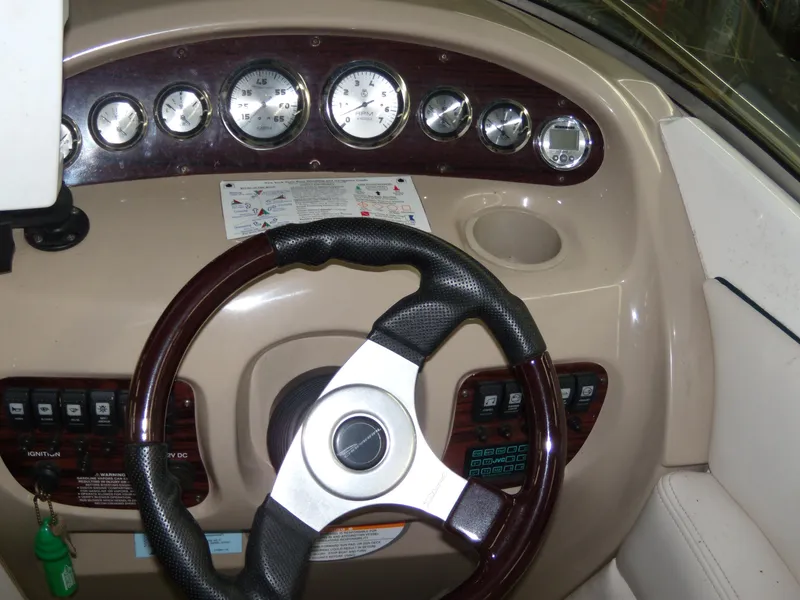 Slide: The Image of Dashboard of a 2000 Chaparral 235 SSi boat with gauges and steering wheel. - 7