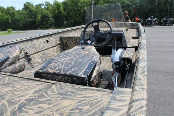 Slide: The Image of 2023 Lowe Roughneck 1860SC boat with camo interior and steering console. - 2