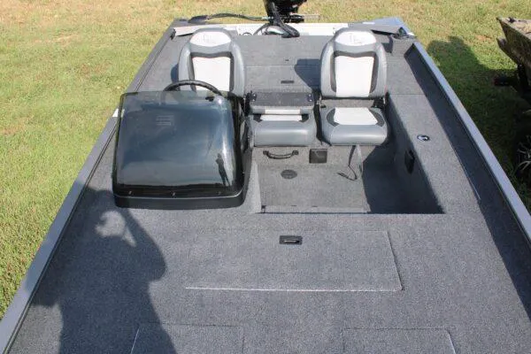 Slide: The Image of 2023 Lowe Legacy boat interior with dual seats and steering console. - 2