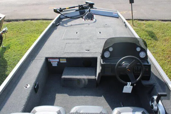 Slide: The Image of 2023 Lowe Legacy boat interior with steering console and seating. - 5